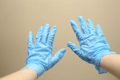 Close-up of hands against blue background