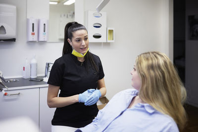 Female dentist with patient in office