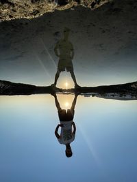 Low angle view of silhouette people in water