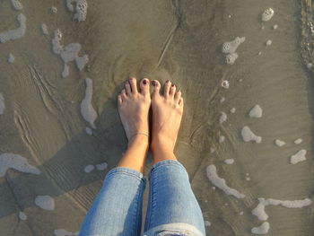 Low section of woman standing on ground