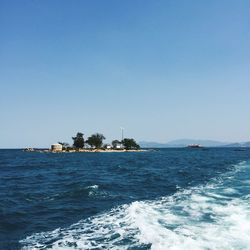 Scenic view of sea against clear blue sky on sunny day