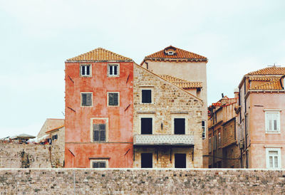 Old buildings against sky in city