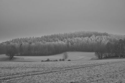 Scenic view of snowy field against clear sky