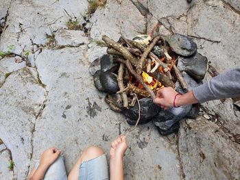 Low section of people relaxing on rock