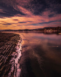 Scenic view of sea against romantic sky at sunset