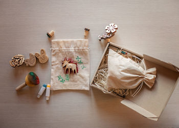 Girl doing craft wrapping for festive gifts with wooden stamp printing technique