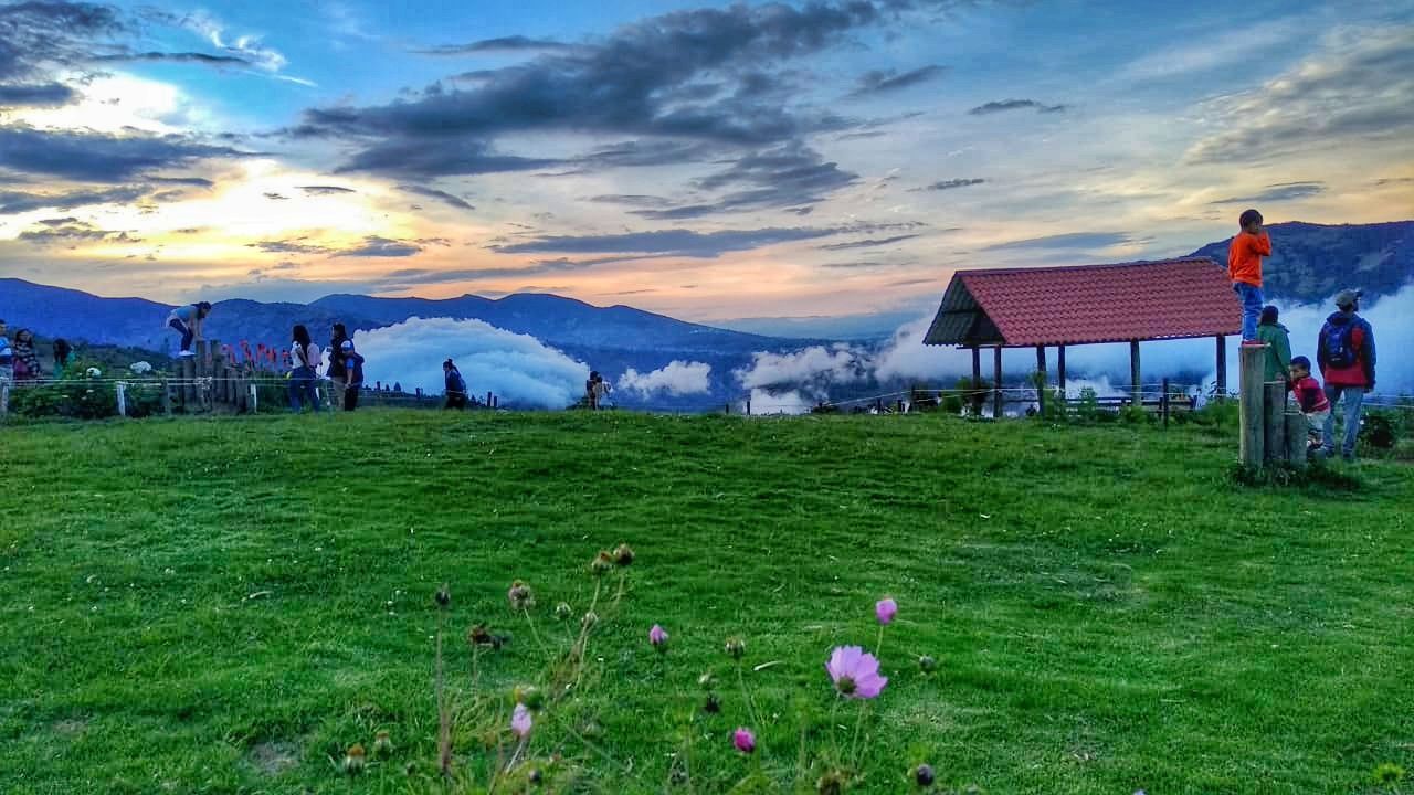 grass, sky, cloud - sky, plant, sunset, field, nature, land, beauty in nature, landscape, architecture, scenics - nature, environment, tranquility, mountain, tranquil scene, built structure, building exterior, agriculture, rural scene, outdoors