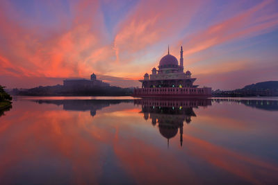 Reflection of temple in water at sunset