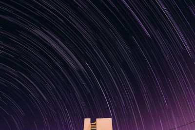 Low angle view of fireworks against sky at night