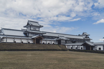 Houses on field against sky