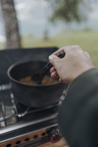 Close-up of hand holding tea cup