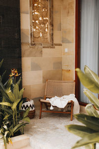 Wicker chair with a white blanket on the summer veranda. balinese style home decor. vertical