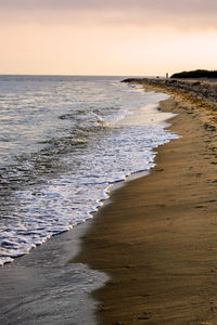 Scenic view of beach against sky during sunset