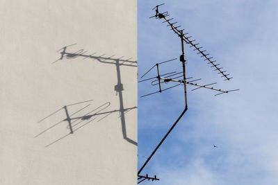 Shadow of antenna on white wall against sky during sunny day