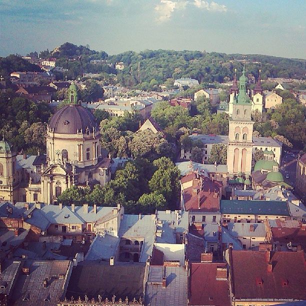 building exterior, architecture, built structure, high angle view, cityscape, city, crowded, residential district, residential building, residential structure, townscape, town, house, tree, sky, roof, church, history, community, outdoors