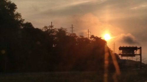 Low angle view of silhouette trees against sky during sunset