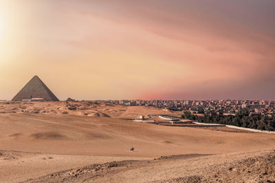 Scenic view of desert against sky during sunset