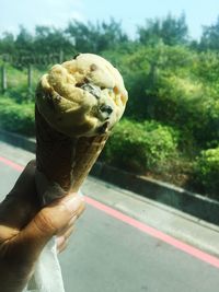 Close-up of hand holding ice cream cone