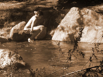 Reflection of person in river stream