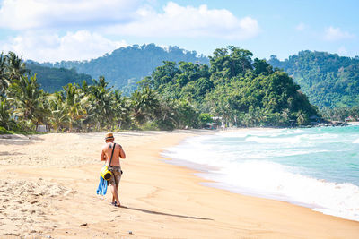 Full length of man on beach against sky