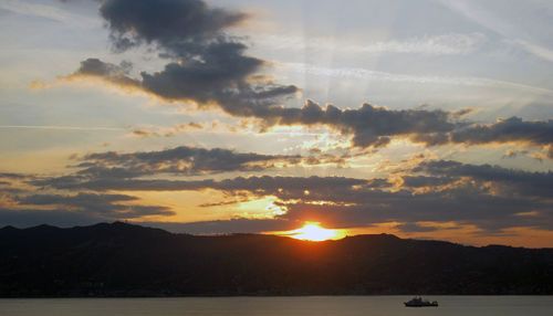 Scenic view of silhouette mountains against sky during sunset