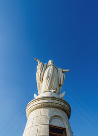 Low angle view of statue against blue sky