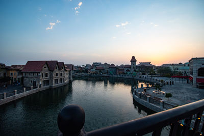 View of buildings in city at sunset