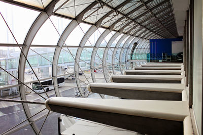 Empty chairs and tables in restaurant against sky