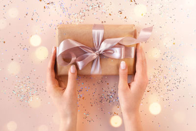 Cropped hand of woman holding gift