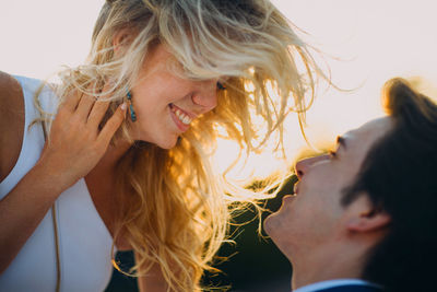 Close-up of bridegroom embracing outdoors