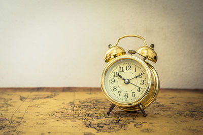 Close-up of alarm clock on table