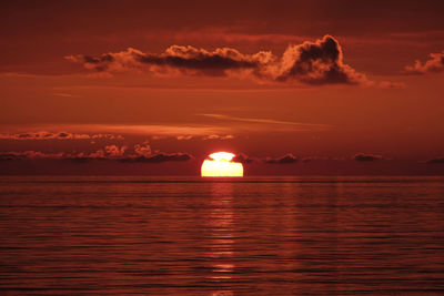 Scenic view of sea against romantic sky at sunset