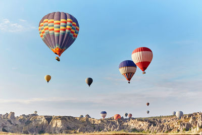 Hot air balloons flying over land