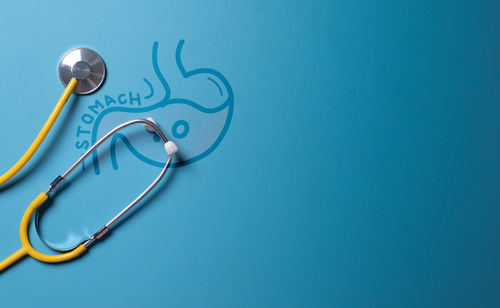 Directly above shot of stethoscope on blue background