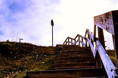 Low angle view of steps amidst buildings against sky