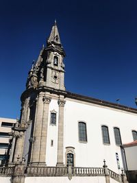 Low angle view of clock tower against clear sky