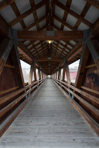 View along covered truss bridge