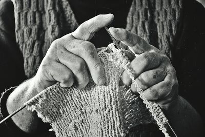 Midsection of woman knitting wool