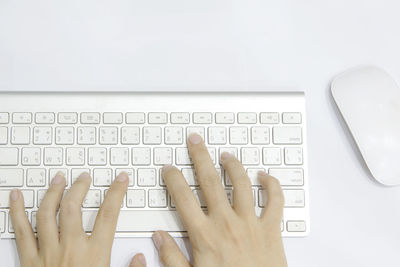 Directly above shot of computer keyboard against white background