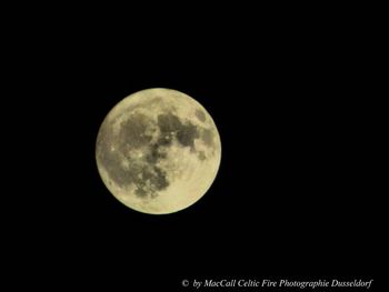 Low angle view of moon against clear sky at night