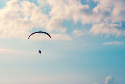 Low angle view of person paragliding