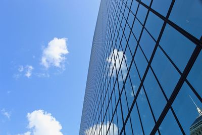 Low angle view of glass building against sky