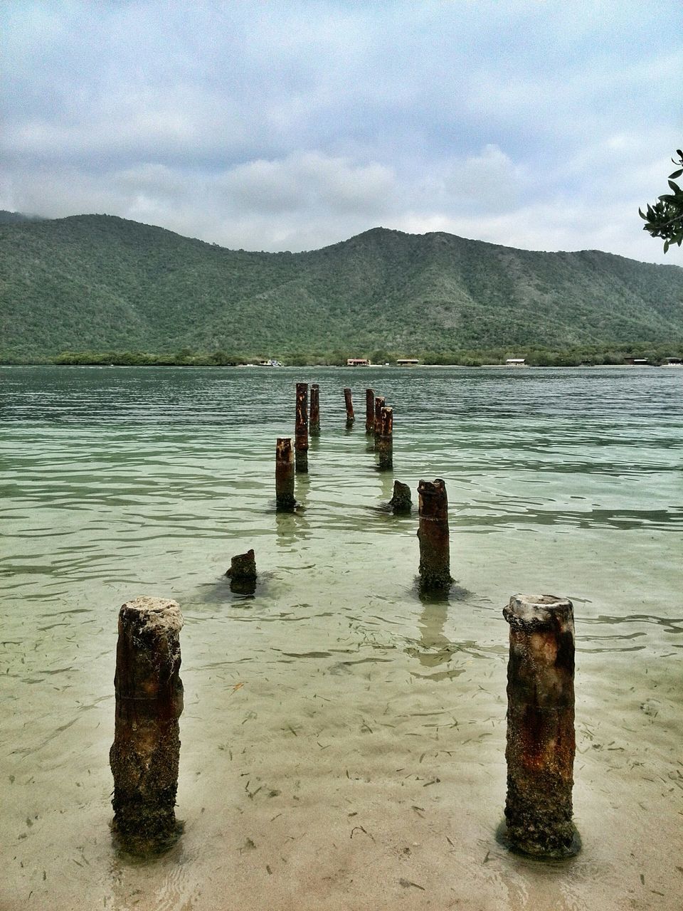 mountain, water, sky, tranquil scene, tranquility, lake, mountain range, scenics, pier, beauty in nature, nature, wood - material, cloud - sky, idyllic, wooden post, cloud, non-urban scene, jetty, outdoors, day