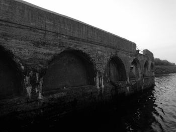 View of old bridge over canal