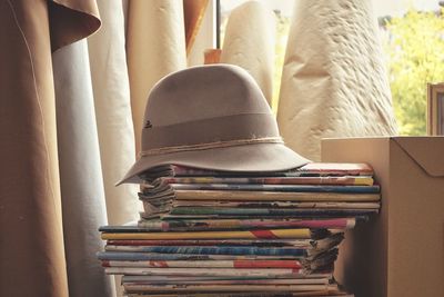 Close-up of hat on stacked book