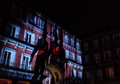 Low angle view of illuminated buildings in city at night