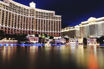 Reflection of buildings in city at night