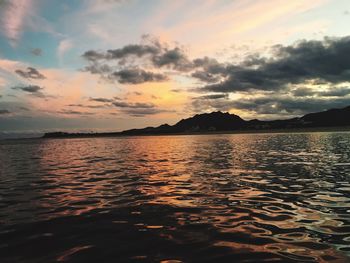 Scenic view of dramatic sky over sea during sunset