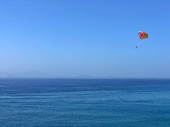 Parachute flying over blue sea