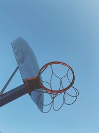 Low angle view of basketball hoop against blue sky